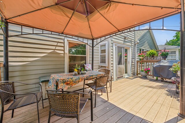 3703 Beard Ave N, Robbinsdale, MN 55422 - wooden terrace featuring outdoor dining area, a grill, and a gazebo