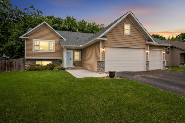 527 1st Ave NE, Lonsdale, MN 55046 - view of front of house featuring an attached garage, asphalt driveway, stone siding, and a shingled roof