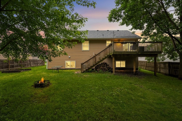 527 1st Ave NE, Lonsdale, MN 55046 - back of property with a fire pit, stairs, a wooden deck, and a fenced backyard