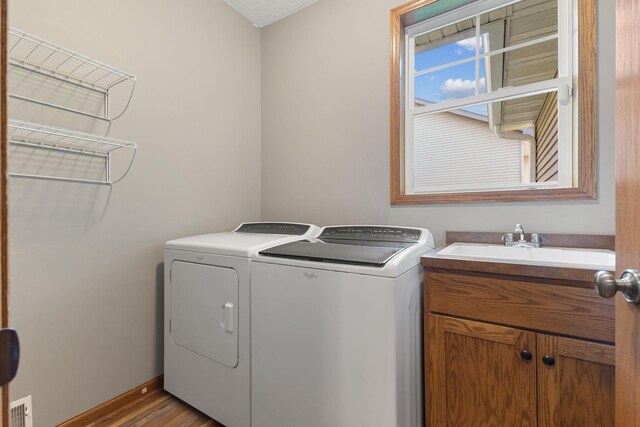 527 1st Ave NE, Lonsdale, MN 55046 - laundry room with independent washer and dryer, cabinet space, and wood finished floors