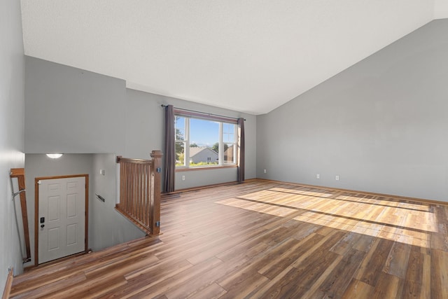 527 1st Ave NE, Lonsdale, MN 55046 - unfurnished room featuring vaulted ceiling and wood finished floors