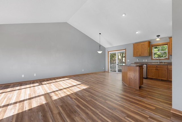 527 1st Ave NE, Lonsdale, MN 55046 - kitchen featuring brown cabinetry, dark wood-type flooring, high vaulted ceiling, a kitchen island, and decorative light fixtures
