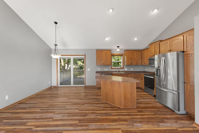 527 1st Ave NE, Lonsdale, MN 55046 - kitchen with stainless steel appliances, lofted ceiling, dark wood-type flooring, a kitchen island, and decorative light fixtures