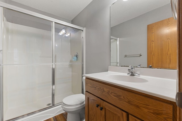 527 1st Ave NE, Lonsdale, MN 55046 - bathroom featuring vanity, a shower stall, a textured ceiling, and wood finished floors