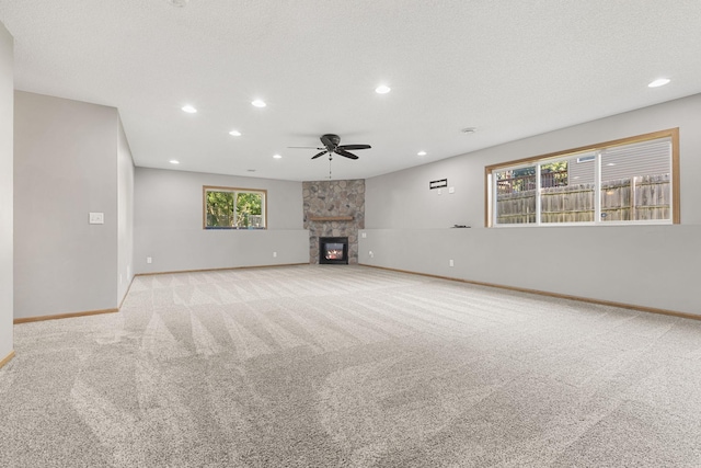 527 1st Ave NE, Lonsdale, MN 55046 - unfurnished living room with ceiling fan, recessed lighting, carpet floors, and a stone fireplace