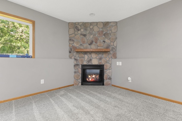 527 1st Ave NE, Lonsdale, MN 55046 - unfurnished living room with a fireplace and carpet floors