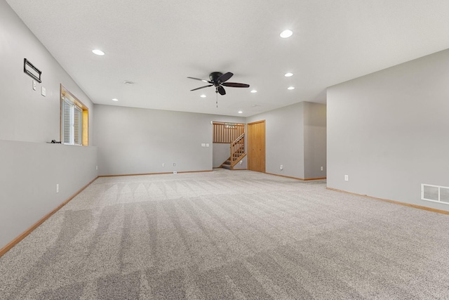 527 1st Ave NE, Lonsdale, MN 55046 - empty room with recessed lighting, ceiling fan, stairs, and light colored carpet