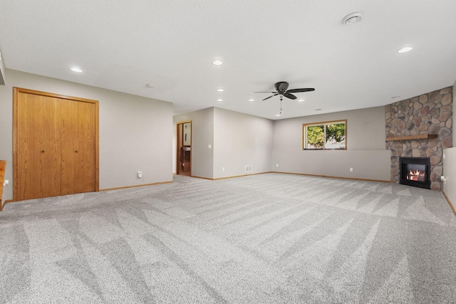 527 1st Ave NE, Lonsdale, MN 55046 - unfurnished living room featuring a ceiling fan, light carpet, a fireplace, and recessed lighting