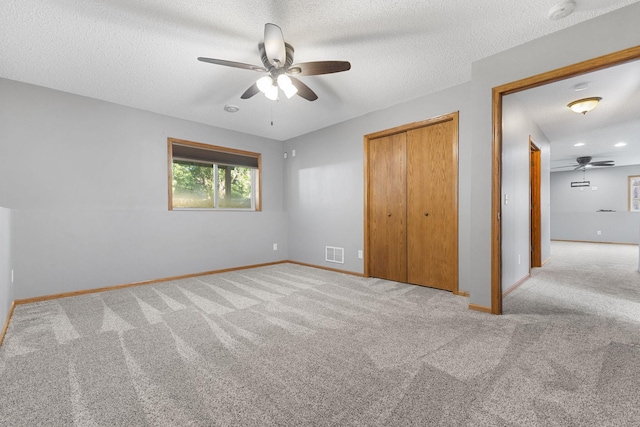 527 1st Ave NE, Lonsdale, MN 55046 - unfurnished bedroom featuring carpet floors, a closet, a textured ceiling, and ceiling fan