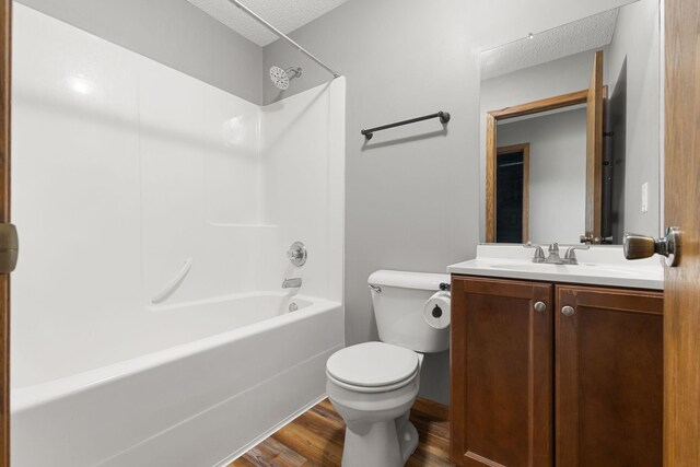 527 1st Ave NE, Lonsdale, MN 55046 - full bath featuring wood finished floors, shower / bathtub combination, vanity, and a textured ceiling