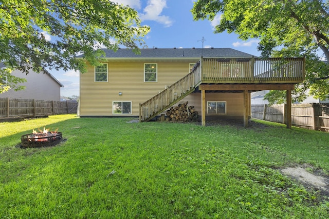 527 1st Ave NE, Lonsdale, MN 55046 - rear view of property featuring an outdoor fire pit, stairway, a wooden deck, and a fenced backyard