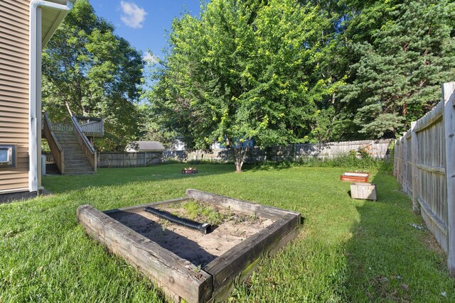 527 1st Ave NE, Lonsdale, MN 55046 - fenced backyard featuring a vegetable garden and stairs