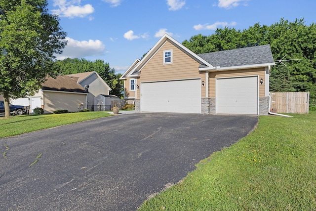 527 1st Ave NE, Lonsdale, MN 55046 - view of front of home with stone siding, asphalt driveway, and a shingled roof