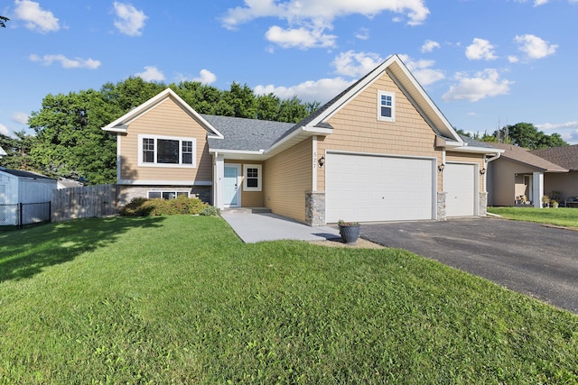 527 1st Ave NE, Lonsdale, MN 55046 - view of front of house featuring asphalt driveway, an attached garage, and stone siding