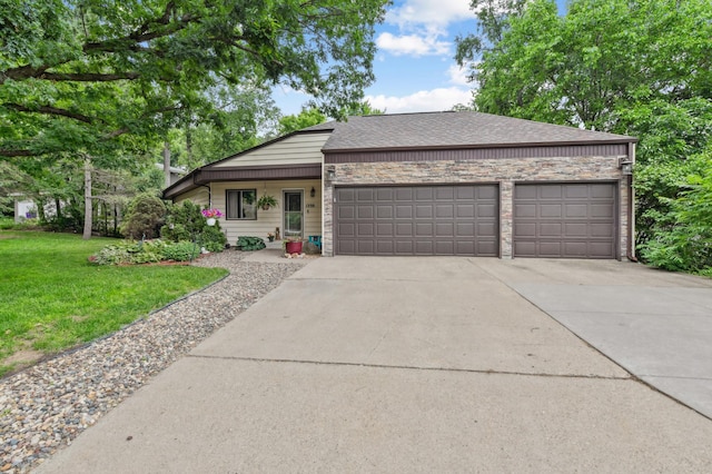 1398 Summit Cir W, Saint Paul, MN 55118 - view of front of house with an attached garage, concrete driveway, a front yard, roof with shingles, and stone siding