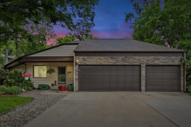 1398 Summit Cir W, Saint Paul, MN 55118 - view of front facade featuring an attached garage, driveway, stone siding, and a shingled roof