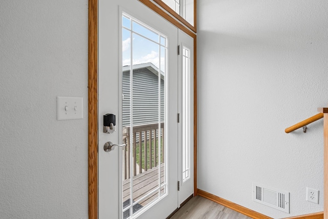 4193 Austin Rd, Owatonna, MN 55060 - doorway to outside with light wood-style flooring and baseboards