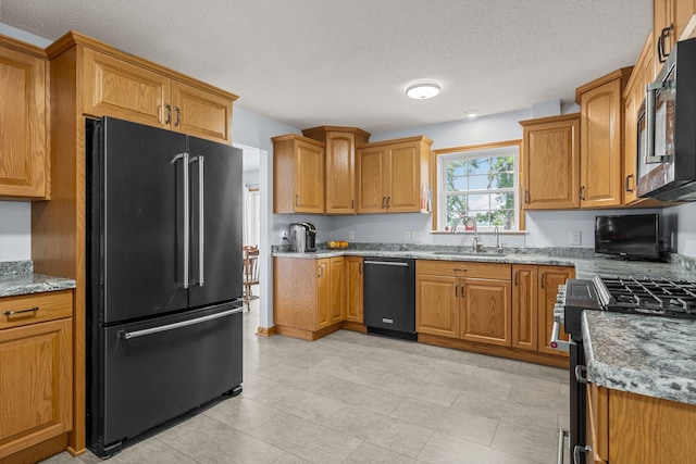 4193 Austin Rd, Owatonna, MN 55060 - kitchen featuring high end fridge, dishwasher, range with gas cooktop, a textured ceiling, and brown cabinets