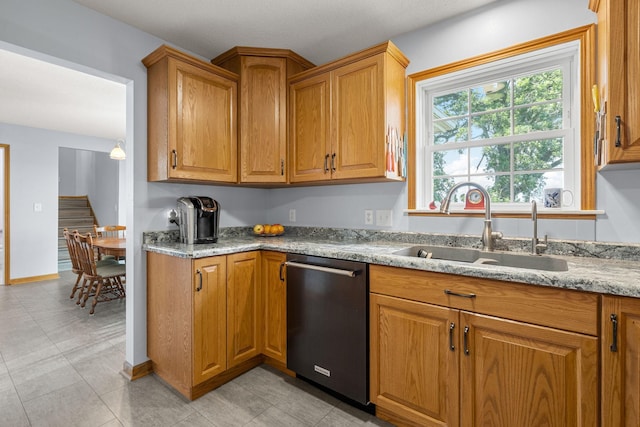 4193 Austin Rd, Owatonna, MN 55060 - kitchen featuring stainless steel dishwasher, brown cabinetry, and light stone countertops
