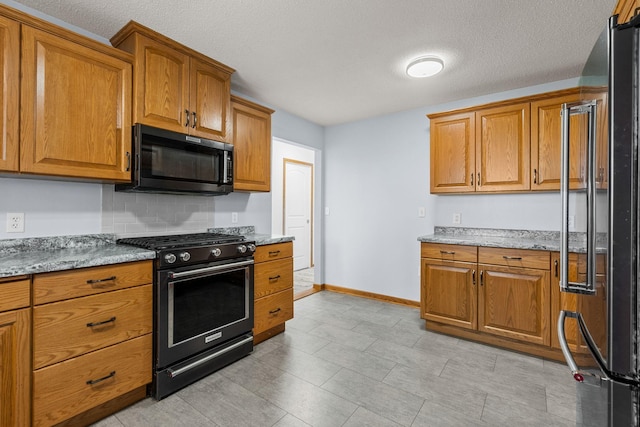 4193 Austin Rd, Owatonna, MN 55060 - kitchen with gas range oven, black microwave, high end refrigerator, brown cabinetry, and a textured ceiling