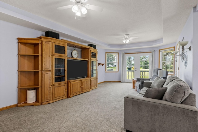 4193 Austin Rd, Owatonna, MN 55060 - living area featuring ceiling fan, light colored carpet, a raised ceiling, and a textured ceiling