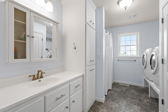 4193 Austin Rd, Owatonna, MN 55060 - bathroom featuring washing machine and dryer, vanity, and a textured ceiling