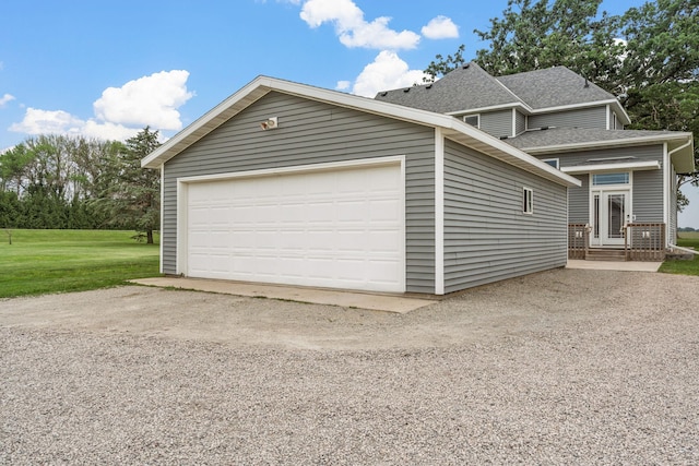 4193 Austin Rd, Owatonna, MN 55060 - view of property exterior with a garage, a shingled roof, an outdoor structure, and a lawn