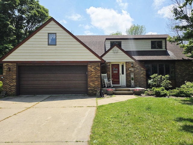 2607 4th Ave NW, Austin, MN 55912 - view of front of property featuring brick siding, concrete driveway, a front yard, and a garage