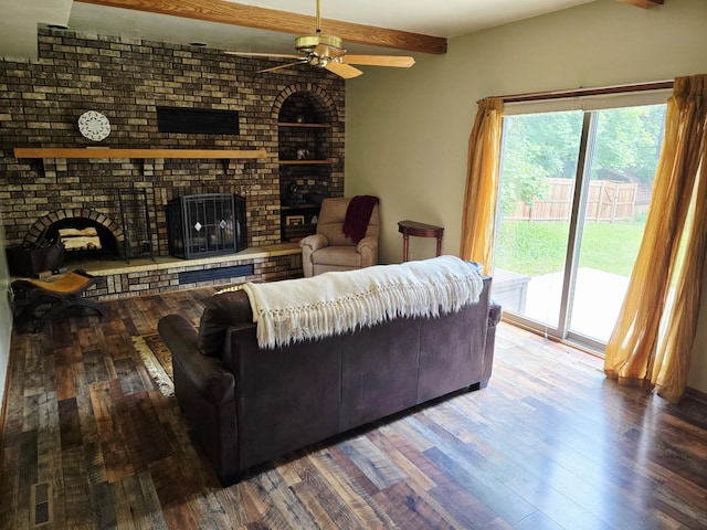 2607 4th Ave NW, Austin, MN 55912 - living room with a brick fireplace, ceiling fan, healthy amount of natural light, wood finished floors, and beam ceiling