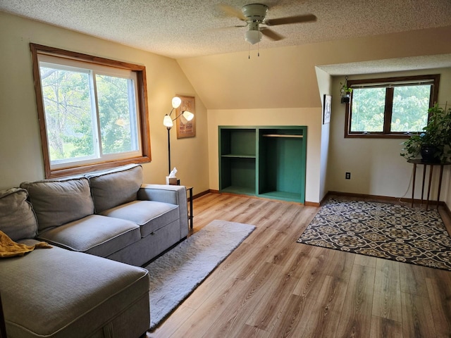 2607 4th Ave NW, Austin, MN 55912 - living area featuring plenty of natural light, a ceiling fan, light wood finished floors, a textured ceiling, and built in features