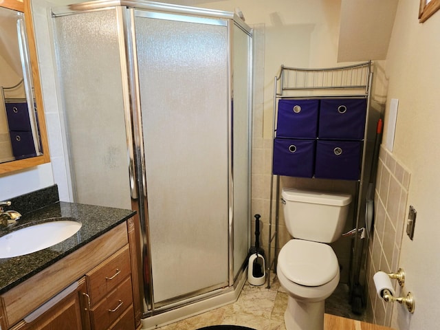 2607 4th Ave NW, Austin, MN 55912 - full bathroom with vanity, a shower stall, tile walls, and a wainscoted wall