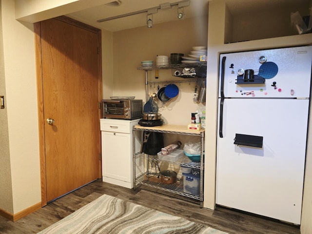 2607 4th Ave NW, Austin, MN 55912 - kitchen featuring freestanding refrigerator, dark wood-style flooring, white cabinetry, and rail lighting