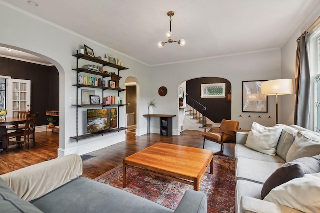 4210 Blaisdell Ave, Minneapolis, MN 55409 - living room featuring arched walkways, wood finished floors, ornamental molding, stairs, and a chandelier