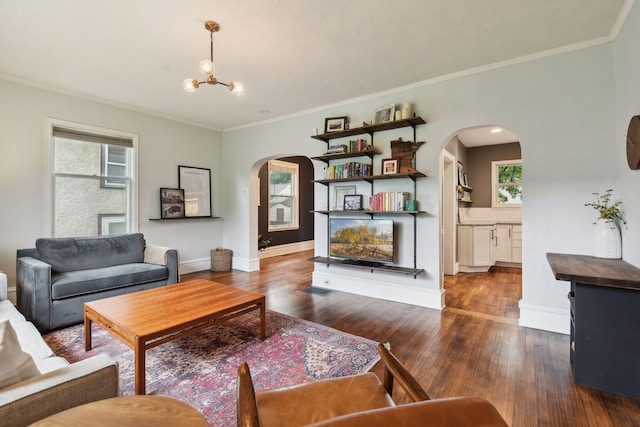 4210 Blaisdell Ave, Minneapolis, MN 55409 - living area featuring arched walkways, dark wood-style flooring, crown molding, plenty of natural light, and a chandelier