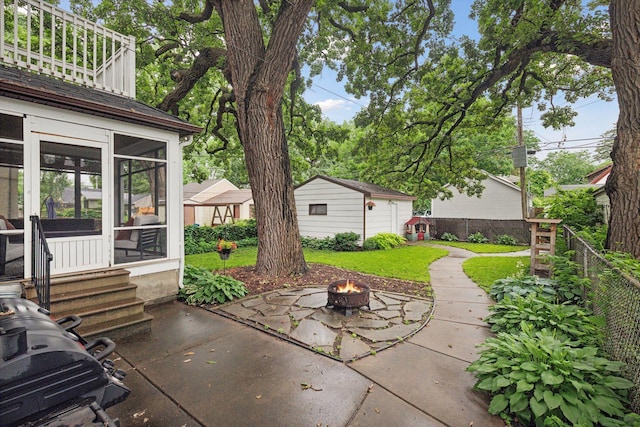 4210 Blaisdell Ave, Minneapolis, MN 55409 - view of patio / terrace with an outdoor fire pit, a sunroom, and entry steps