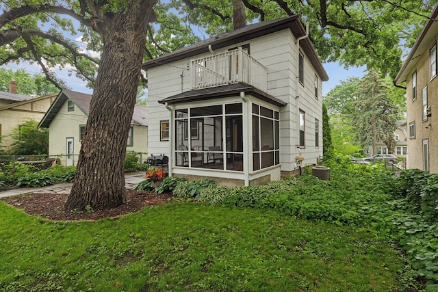 4210 Blaisdell Ave, Minneapolis, MN 55409 - back of property with a balcony, a sunroom, a chimney, and a lawn