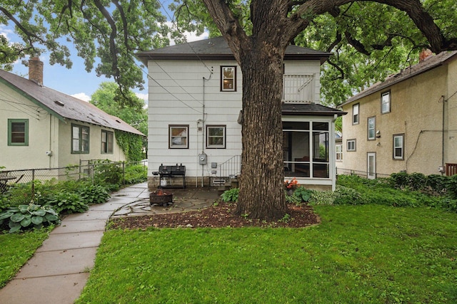 4210 Blaisdell Ave, Minneapolis, MN 55409 - rear view of house featuring a fire pit, a sunroom, and a patio