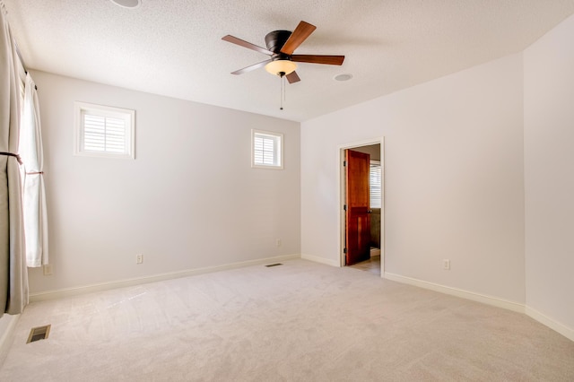 10725 Toledo Ln N, Brooklyn Park, MN 55443 - empty room with a ceiling fan, light colored carpet, and a textured ceiling
