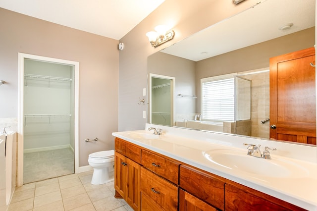 10725 Toledo Ln N, Brooklyn Park, MN 55443 - full bathroom featuring double vanity, a spacious closet, and tile patterned flooring