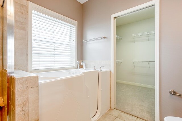 10725 Toledo Ln N, Brooklyn Park, MN 55443 - full bath with a garden tub, tile patterned floors, and a spacious closet