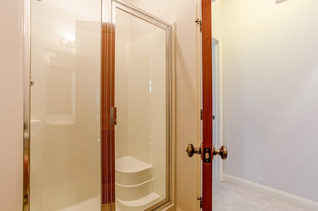 10725 Toledo Ln N, Brooklyn Park, MN 55443 - bathroom featuring a stall shower and baseboards