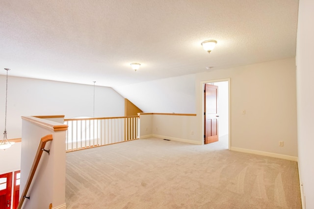 10725 Toledo Ln N, Brooklyn Park, MN 55443 - spare room featuring light colored carpet, lofted ceiling, and a textured ceiling