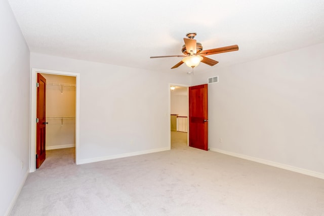 10725 Toledo Ln N, Brooklyn Park, MN 55443 - unfurnished bedroom with light colored carpet, a spacious closet, and ceiling fan