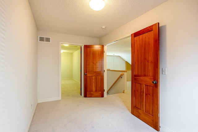 10725 Toledo Ln N, Brooklyn Park, MN 55443 - unfurnished bedroom featuring a spacious closet, carpet, and a textured ceiling