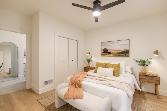 212 Diamond Lake Rd, Minneapolis, MN 55419 - bedroom featuring arched walkways, light wood-style floors, a closet, and ceiling fan