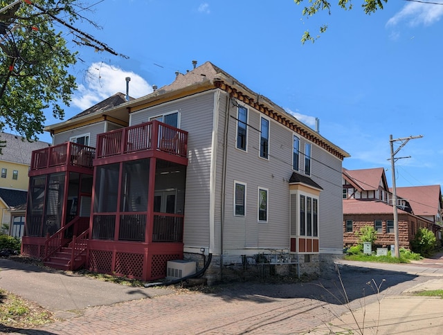 220 Mackubin St Unit 220, Saint Paul, MN 55102 - back of house with a balcony and a sunroom