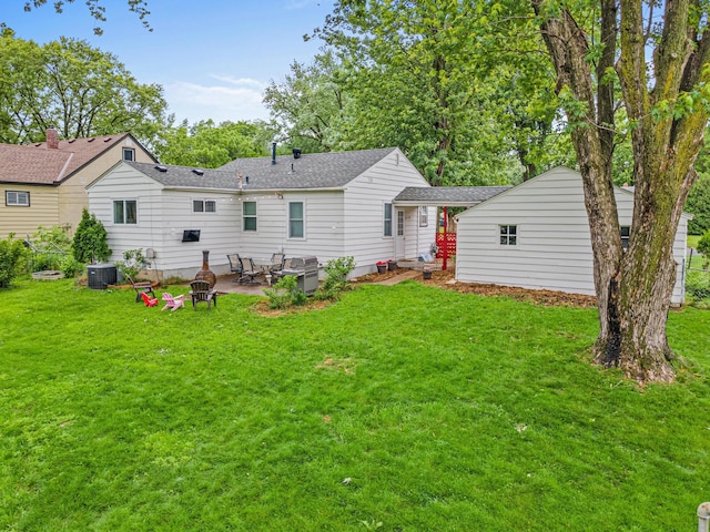 8313 Stevens Ave S, Bloomington, MN 55420 - rear view of house with a patio, a lawn, and roof with shingles