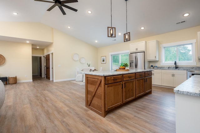 kitchen with stainless steel appliances, a ceiling fan, lofted ceiling, white cabinetry, and recessed lighting