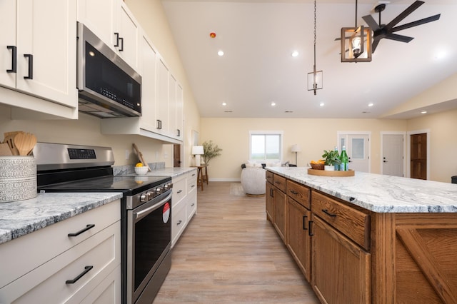 kitchen featuring stainless steel appliances, lofted ceiling, brown cabinetry, light wood-style floors, and white cabinetry