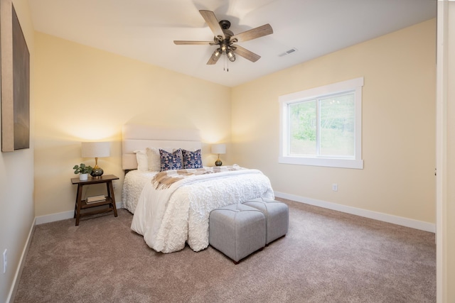 carpeted bedroom with baseboards and ceiling fan